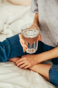 Woman sitting with a glass of water
