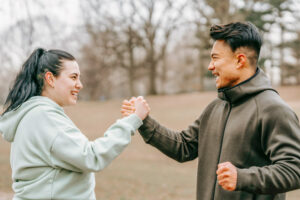 Woman and man clasping fists