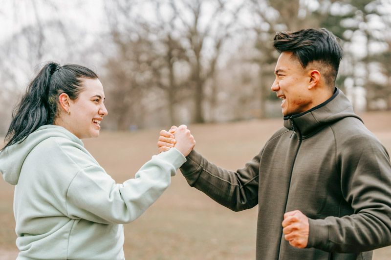 Woman and man clasping fists