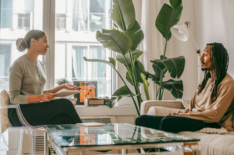 Therapist talking to male patient