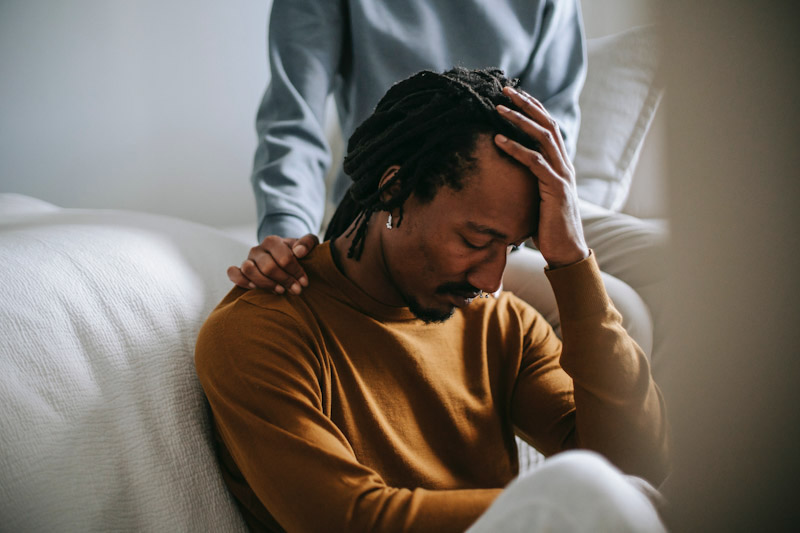 Person consoling a man