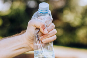 Fist crushing plastic bottle