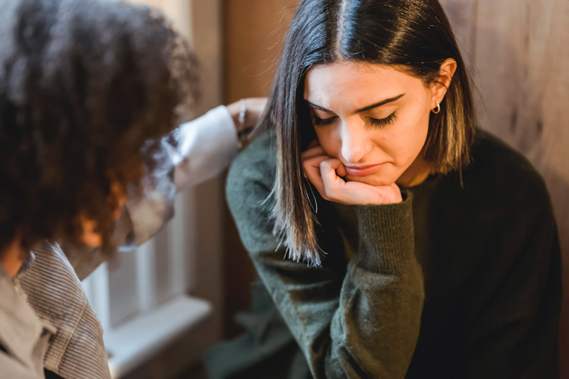 Woman consoling a woman