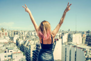 Woman on rooftop overlooking cityscape
