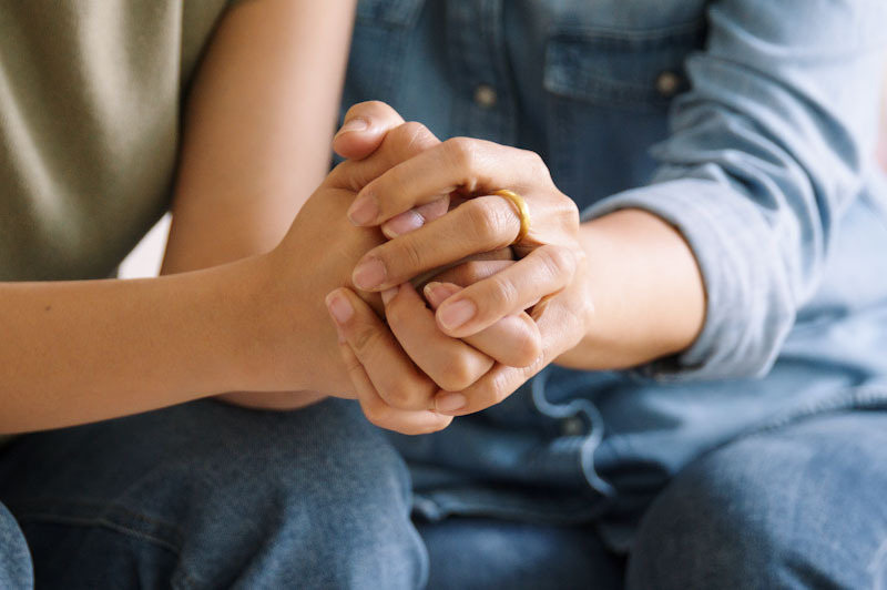 Two people holding hands