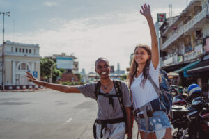 Two women hailing a cab in a city