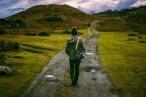 Person walking on path into mountains