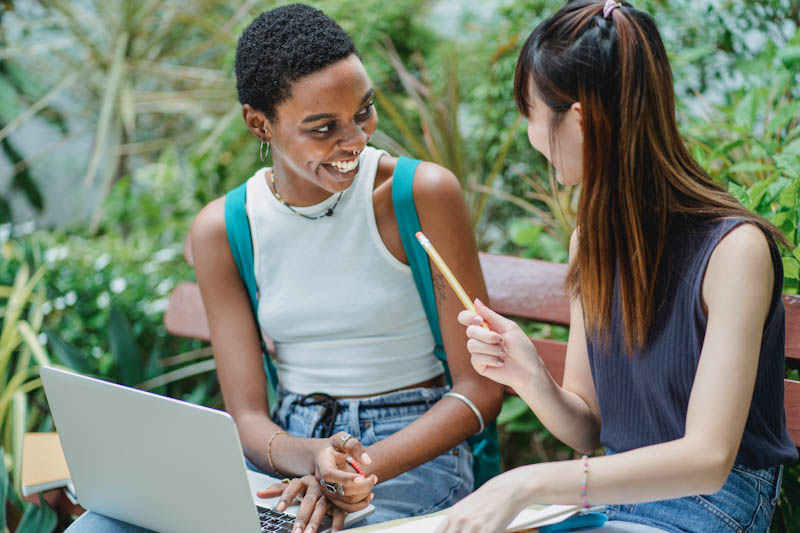 Two women talking in a garden