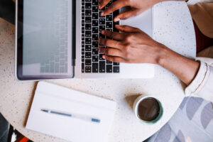 Woman typing on laptop keyboard