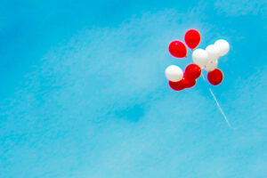 Red and white balloons in the air