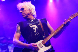 Rock star Ricky Byrd plays guitar in concert