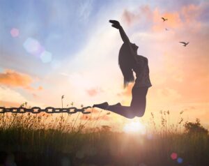 Woman jumping to break free of chains