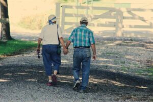 Older couple walking down a street