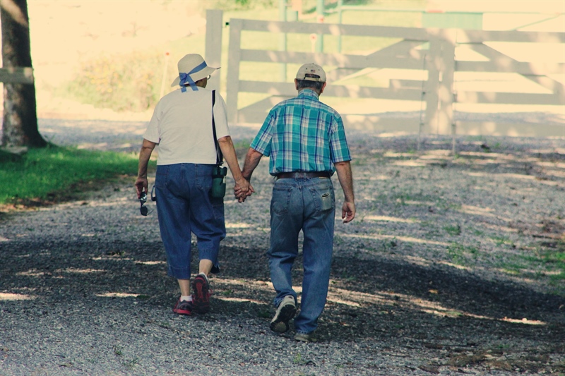 Older couple walking down a street
